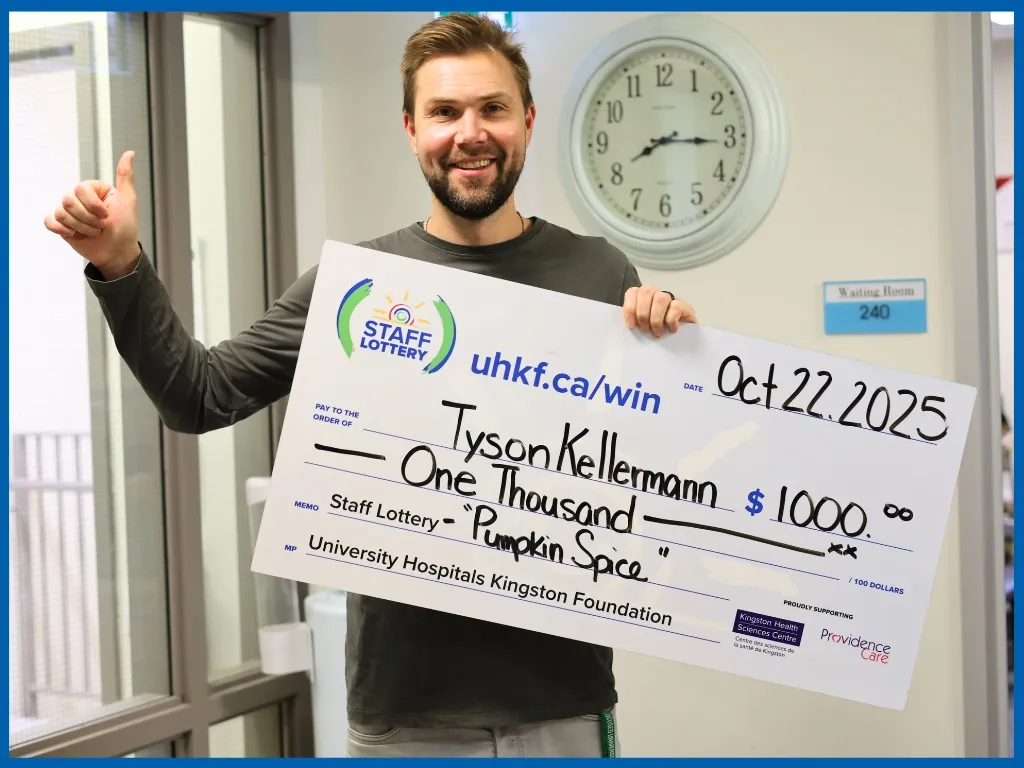 Tyson Kellermann holding large cheque.