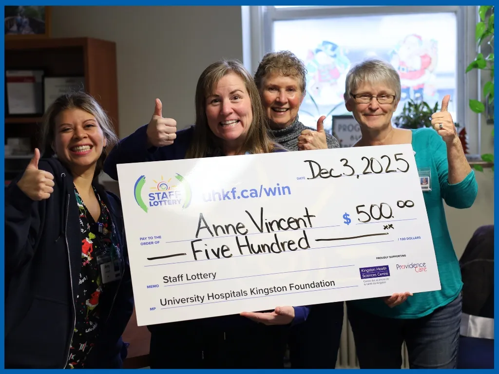 Anne Vincent holding large cheque.