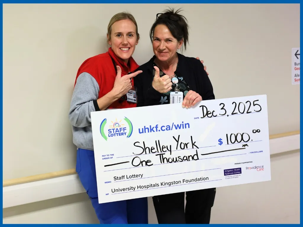 Shelley York holding a large cheque.