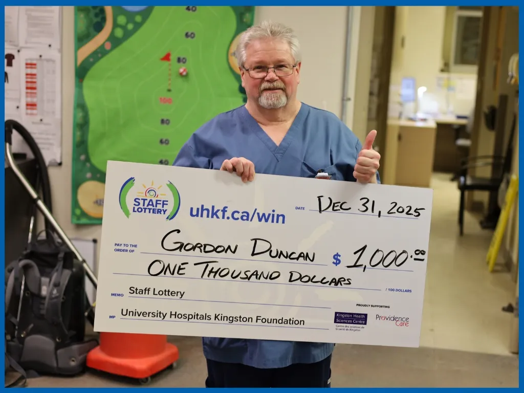 Gordon the Winner holding $1000 chq Dec 31, 2025