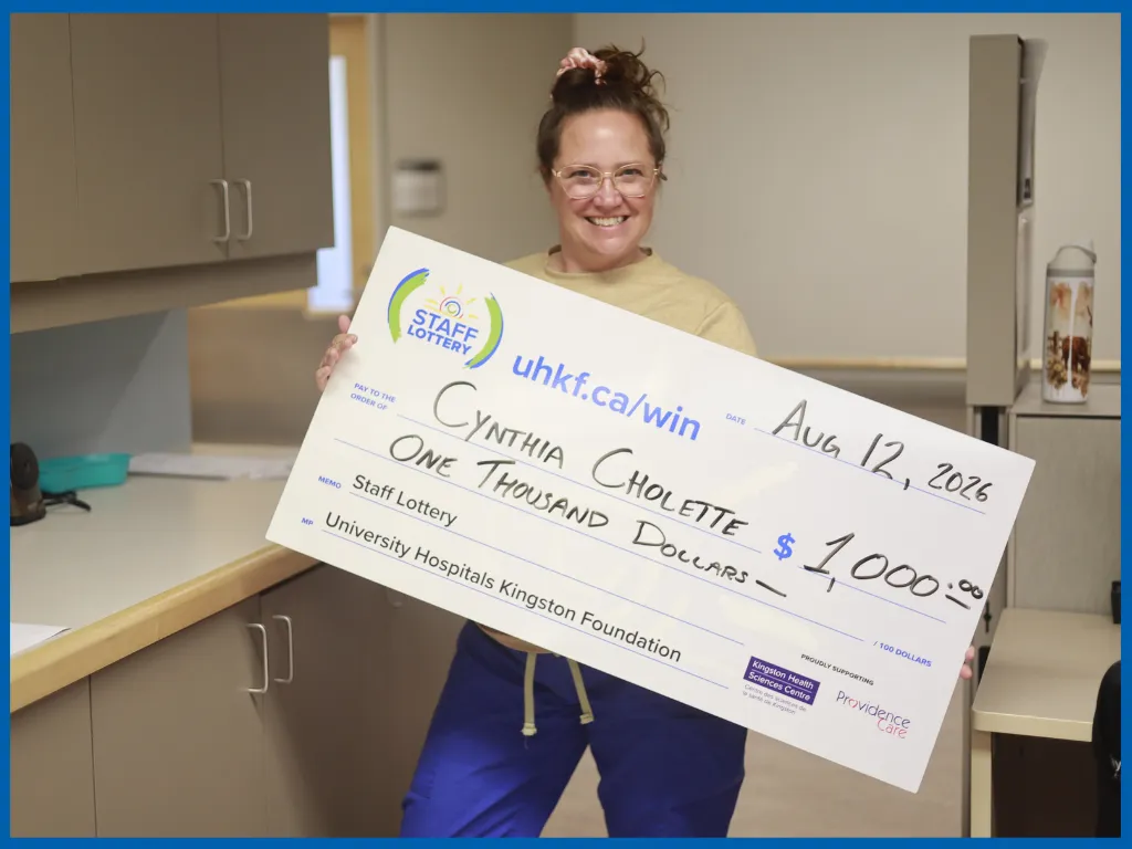 Cynthia Cholette posing with a big cheque.