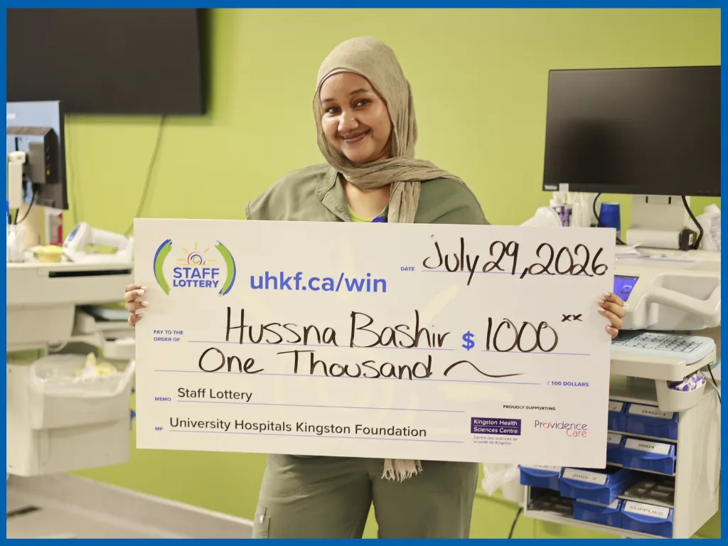 Hussna Bashir posing with a big cheque.