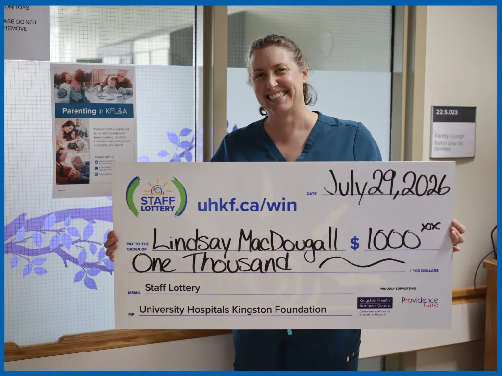 Lindsay MacDougall posing with a big cheque.