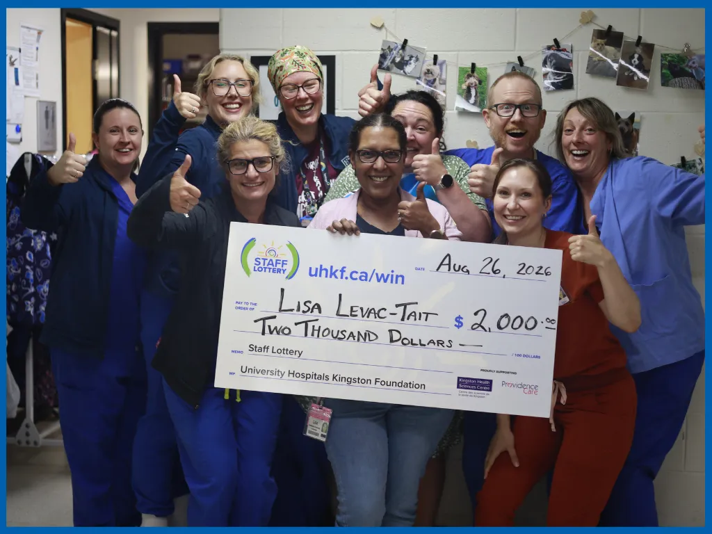 Lisa Levac-Tait posing with a big cheque.