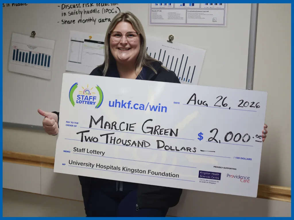 Marcie Green posing with a big cheque.