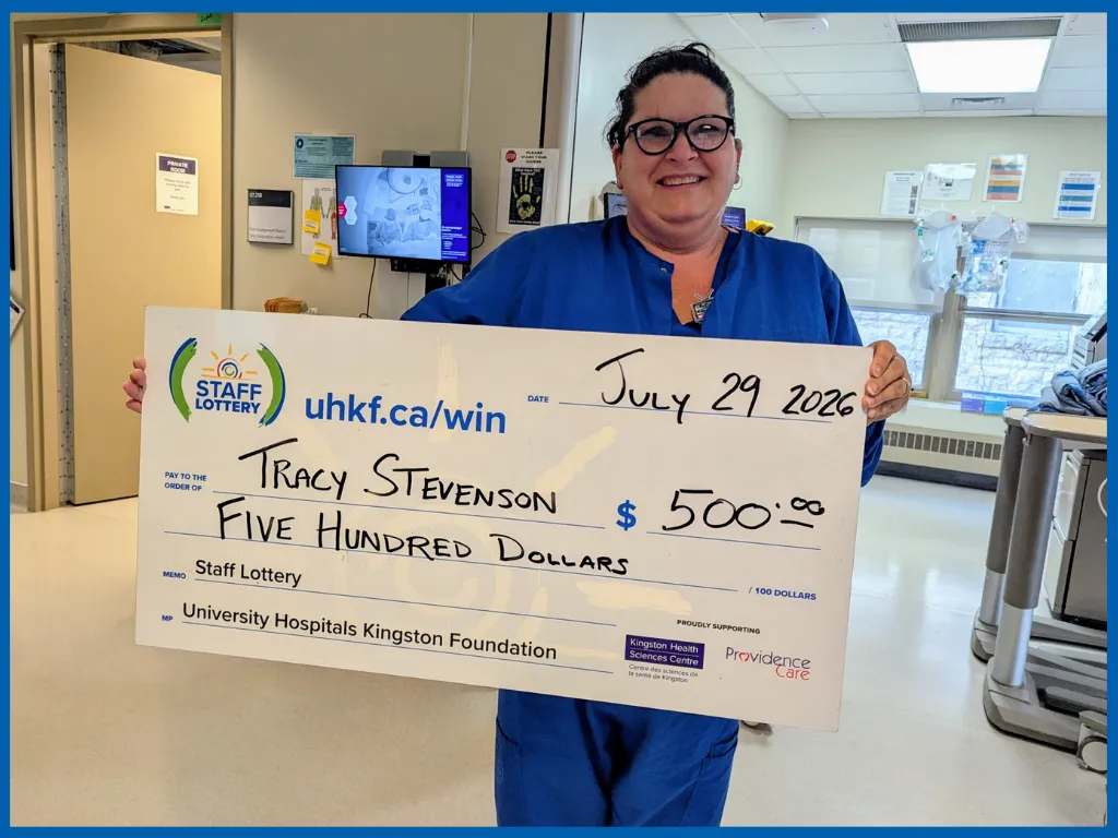 Tracy Stevenson posing with a big cheque.
