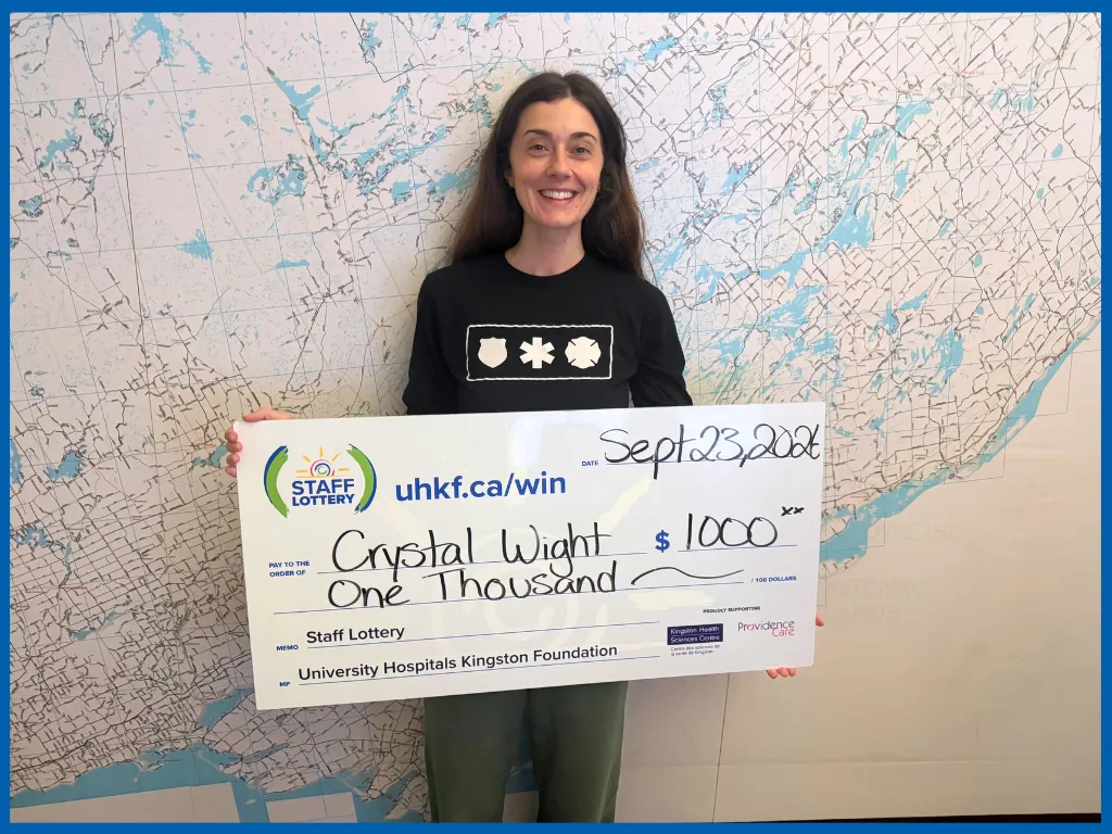 Crystal Wight holding a big Staff Lottery cheque