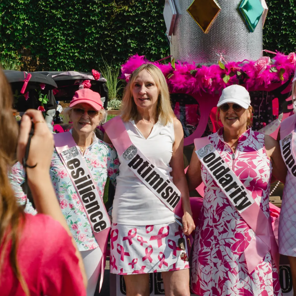 Women wearing pink golfing outfits.