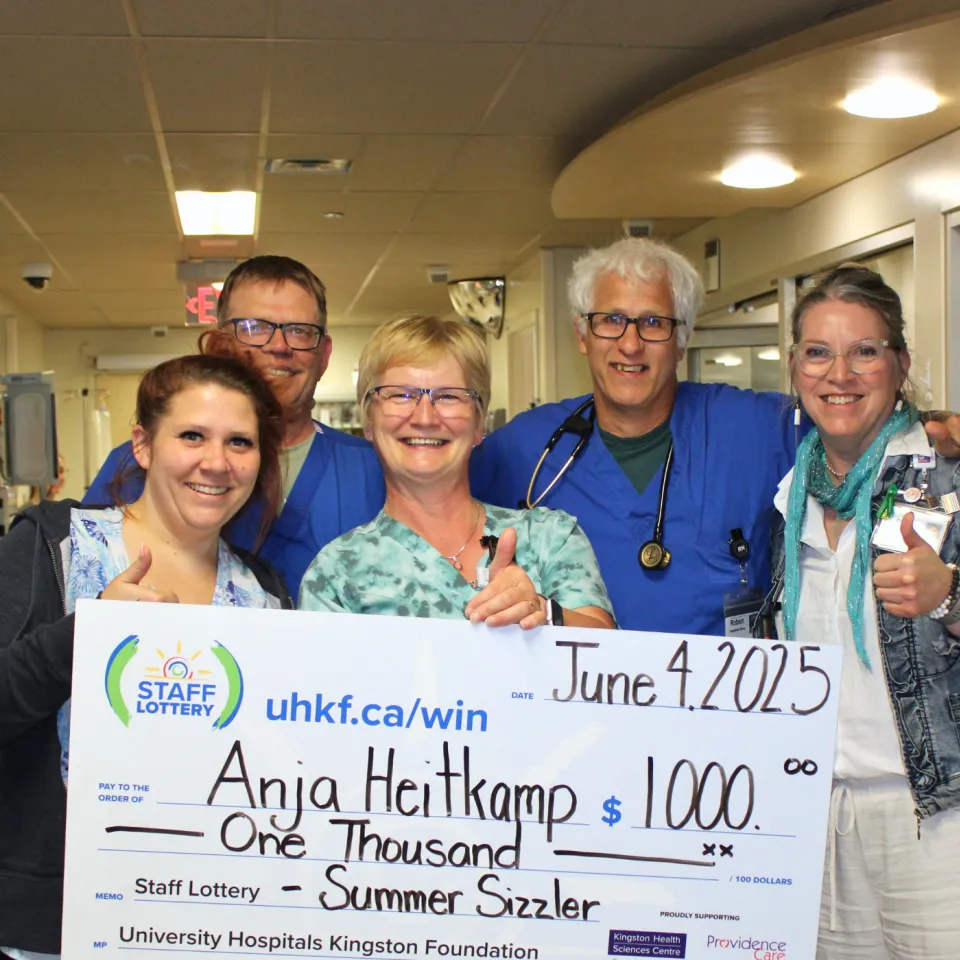Anja Heitkamp and team holding her $1000 staff lottery cheque.