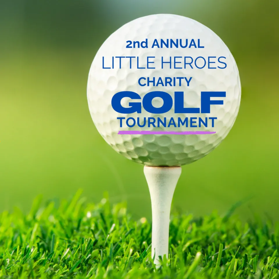 Image of a golf ball and a gold ribbon.
