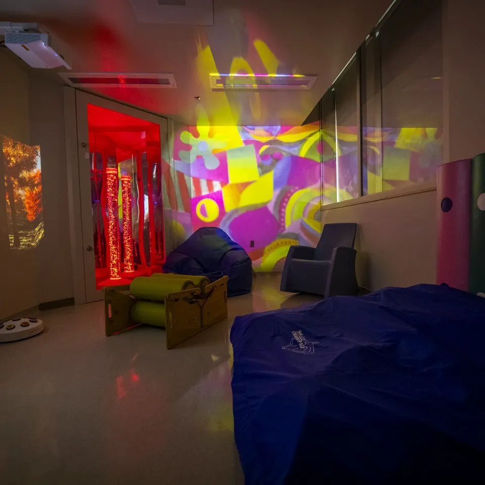 Image of the new multi-sensory room at Kingston Health Sciences Centre with calming lights and comfortable seating.